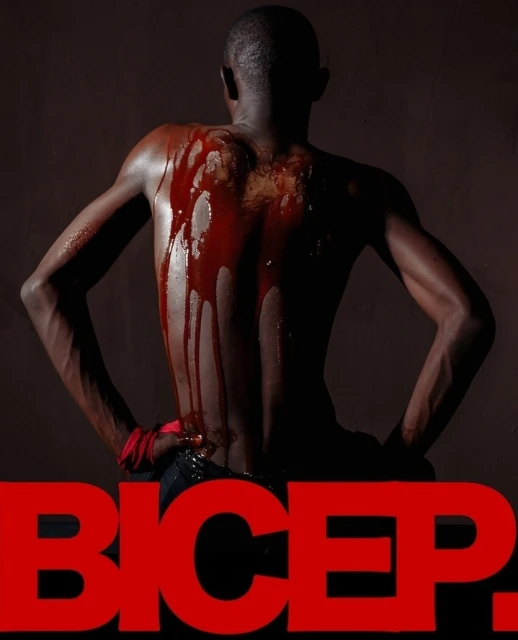 Artistic shot of an adult male with blood-like substance on his back, posing against a dark backdrop with red 'BICEP.' text overlay.