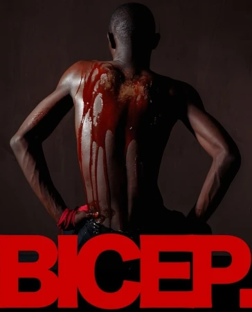 Artistic shot of an adult male with blood-like substance on his back, posing against a dark backdrop with red 'BICEP.' text overlay.