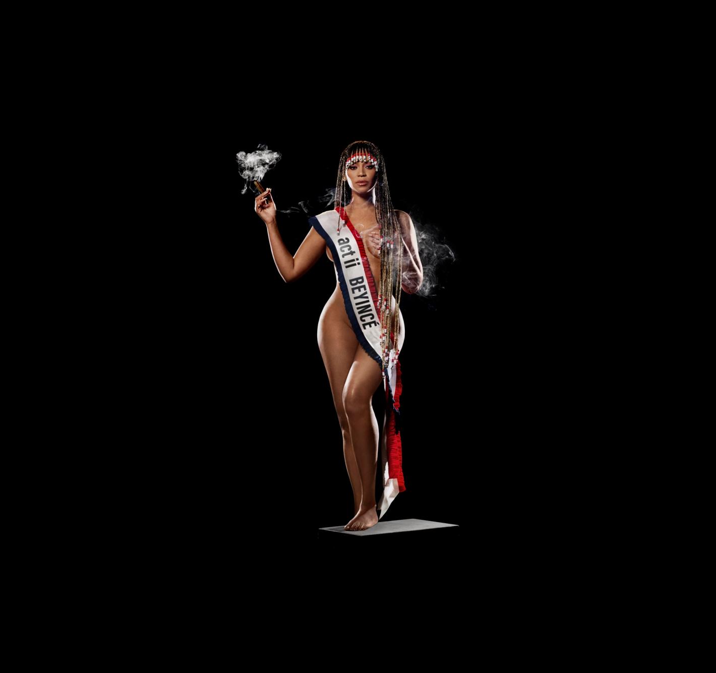 Beyonce poses in a sash, smoking a cigar on a gray platform against a black backdrop in a dramatic studio setting. 