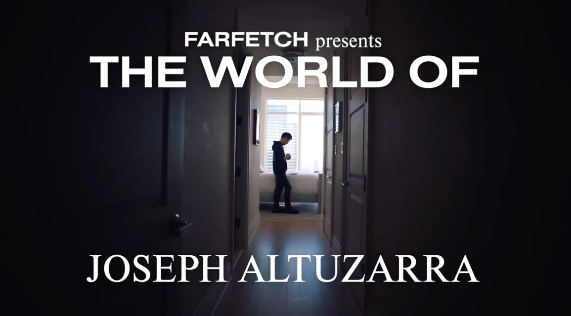 Farfetch presents 'The World of Joseph Altuzarra': A lone male figure gazes at a phone in a sunlit hallway. Dark ambiance frames the scene.