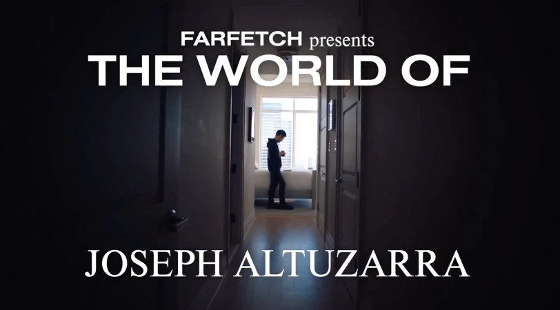 Farfetch presents 'The World of Joseph Altuzarra': A lone male figure gazes at a phone in a sunlit hallway. Dark ambiance frames the scene.