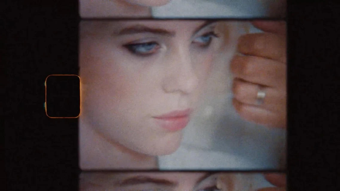 Close-up of an adult woman's face with visible makeup application, framed by a film strip aesthetic, in a vintage-style beauty shot.