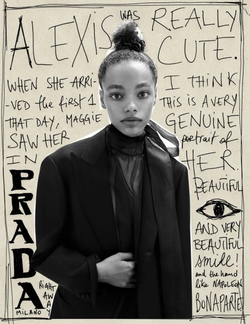 Monochrome studio portrait of a young adult woman with styled hair, wearing a black jacket, set against a backdrop of handwritten text and drawings.