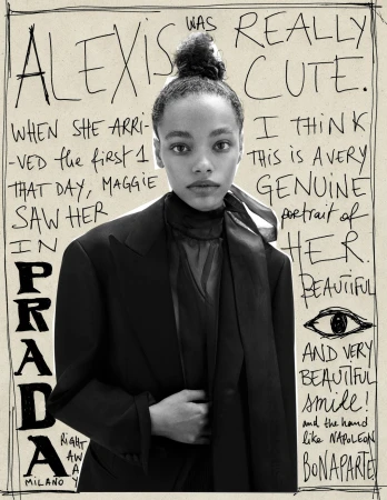 Monochrome studio portrait of a young adult woman with styled hair, wearing a black jacket, set against a backdrop of handwritten text and drawings.