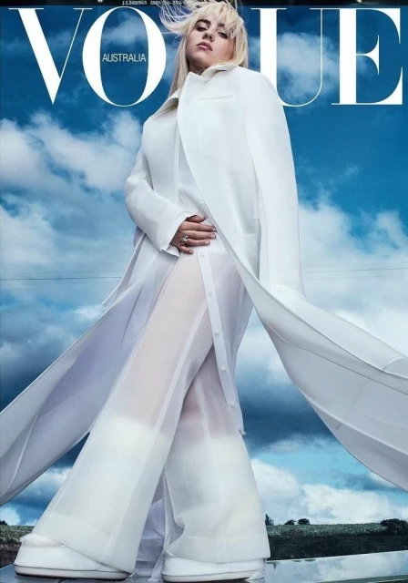 Vogue Australia cover featuring a fashion model in a white outfit posing outdoors with a blue sky and clouds in the background.