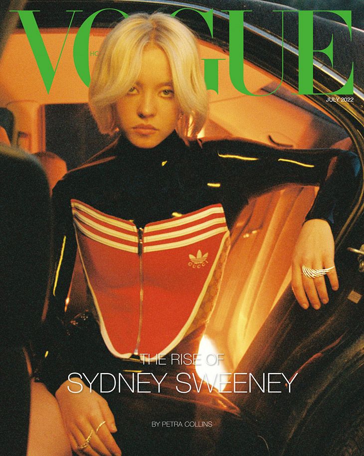 Vogue cover featuring Sydney Sweeney, blonde bob, black and red Adidas tracksuit, July 2022 issue, indoor setting, soft lighting.