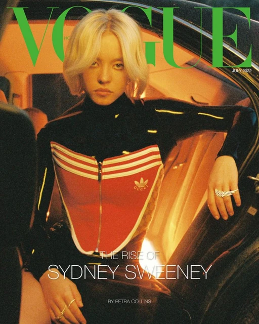 Vogue cover featuring Sydney Sweeney, blonde bob, black and red Adidas tracksuit, July 2022 issue, indoor setting, soft lighting.