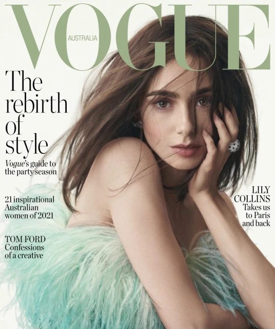 Lily Collins graces the cover of Vogue Australia, with flowing brown hair, wearing a feathered aqua top and holding her hand to her face.