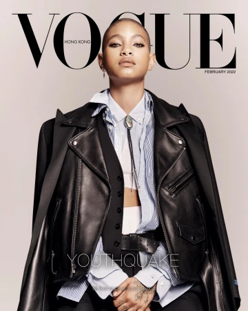 Vogue Hong Kong cover featuring a person with dark hair wearing a black leather jacket, striped shirt, and black vest against a neutral background.