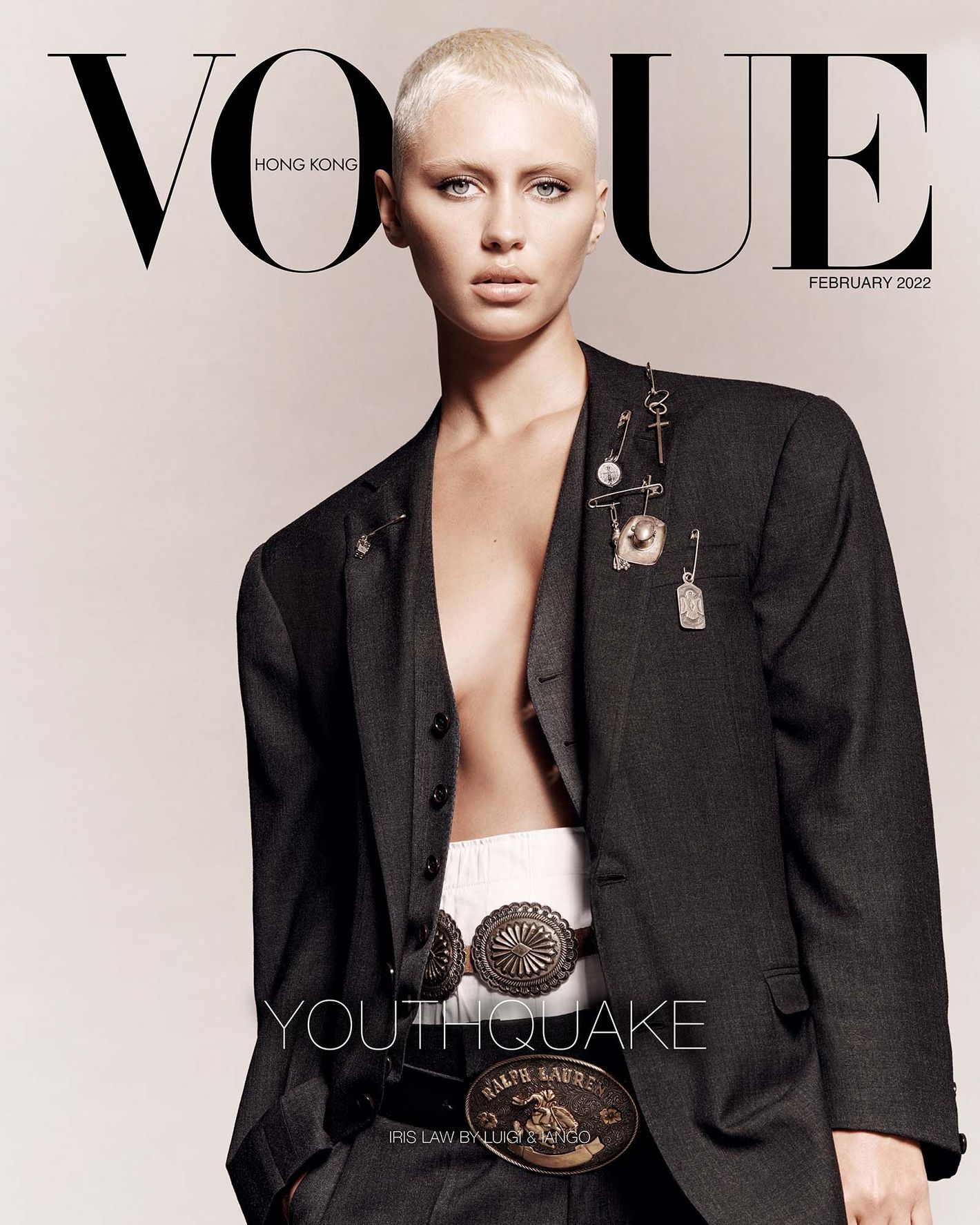 Vogue Hong Kong cover featuring a fair-skinned adult woman in a black blazer, white top, and belt with a light-beige background.