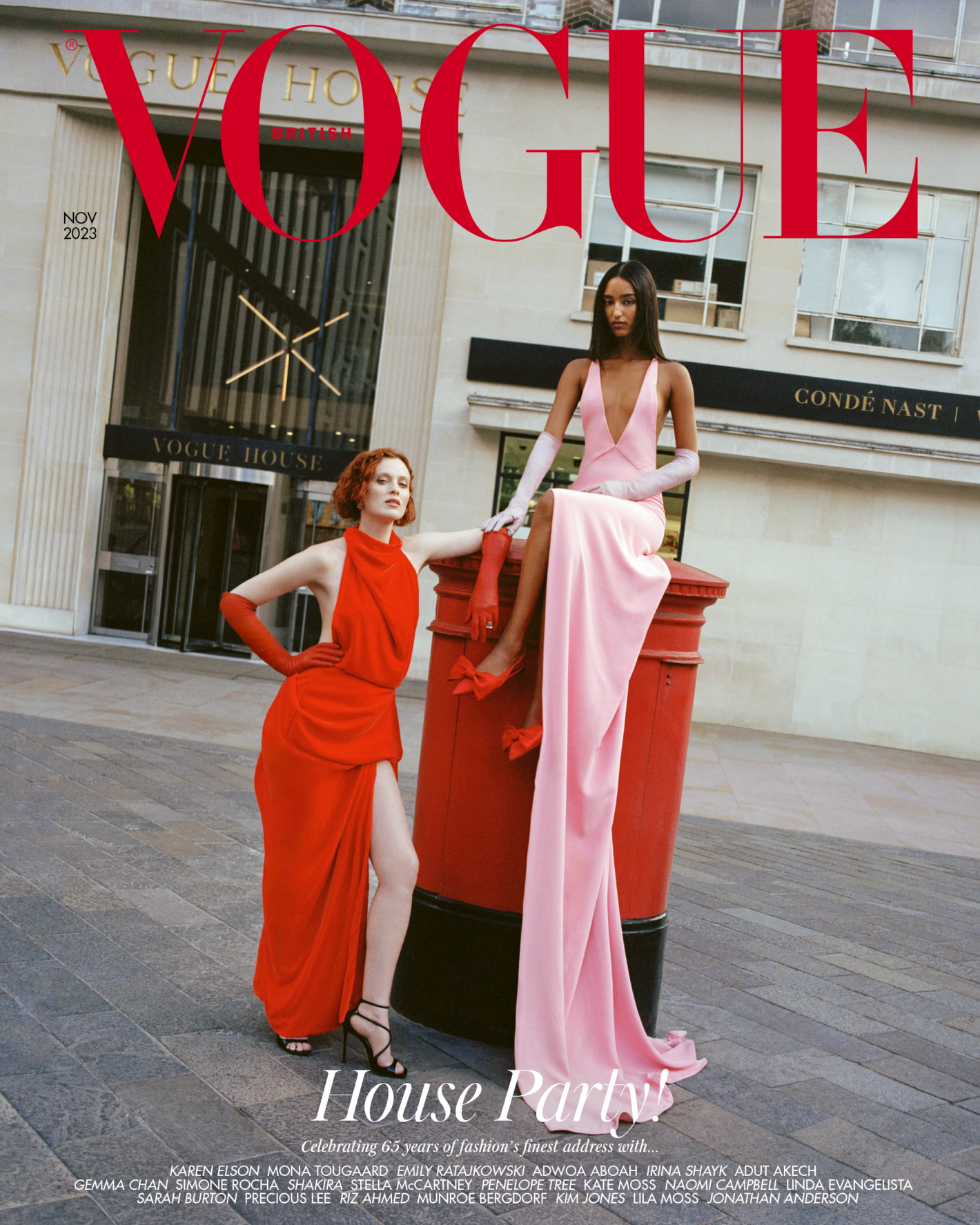 Two fashion models pose next to a red British postbox in front of the Vogue House building, cover for Vogue, November 2023.