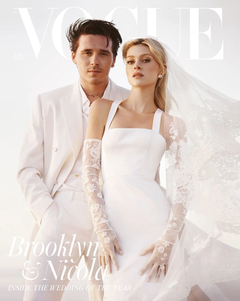 A Vogue cover shows a fashionable couple posing outdoors in formal wedding attire. The groom is in a white suit and the bride is in a wedding dress.