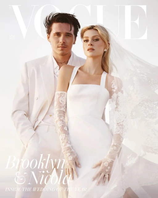 A Vogue cover shows a fashionable couple posing outdoors in formal wedding attire. The groom is in a white suit and the bride is in a wedding dress.