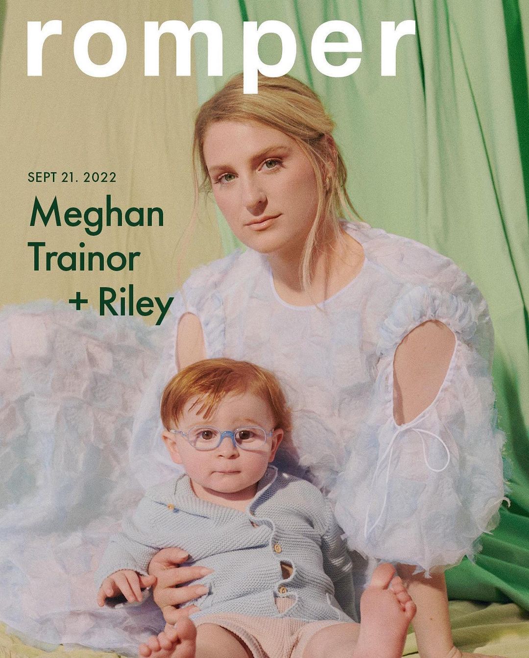 Magazine cover featuring Meghan Trainor and her child Riley, wearing glasses, in front of a light green curtain backdrop.