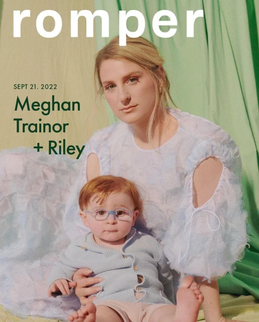 Magazine cover featuring Meghan Trainor and her child Riley, wearing glasses, in front of a light green curtain backdrop.