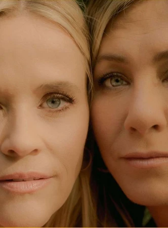 Close-up portrait of two blonde women with blue eyes filling the frame, photographed by Amy Harrity.