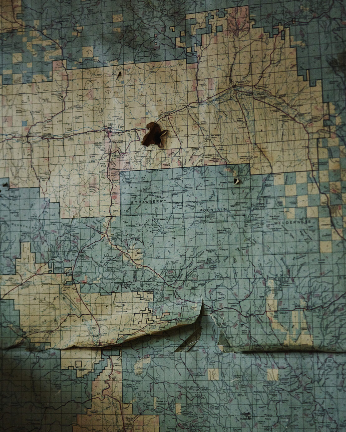 Detailed vintage map featuring geographical outlines, route markings, and a weathered texture with visible wear and tear.