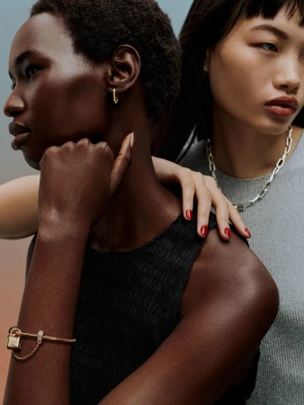 Close-up portrait of two female models wearing jewellery, photographed by Daniel Benson in London