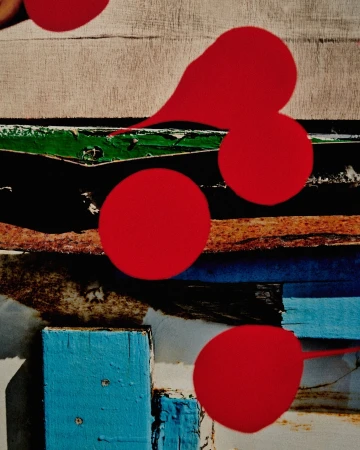 Abstract art featuring red circles and colorful wooden planks in blue, green, and white.