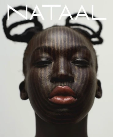 Close-up portrait of a woman with dark skin and intricate makeup featuring vertical stripes, accented by unique hairstyle and bold red lips.