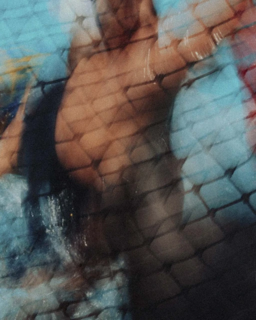 Abstract image of an athletic male figure swimming underwater with light reflections and tile-like texture patterns in shades of blue and brown.
