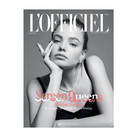 Monochrome magazine cover portrait of Kristine Froseth wearing a dark tank top and diamond jewelry against a plain grey background