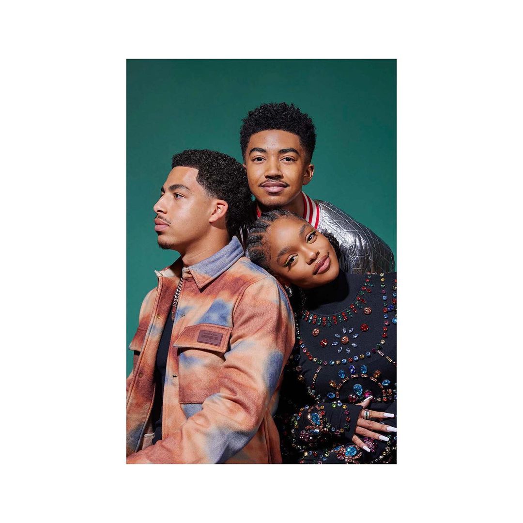Portrait of three young adults posed closely together against a solid teal studio background by Maggie Shannon