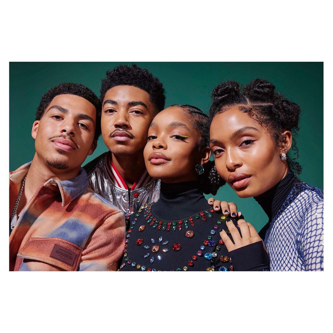 Group portrait of four young adults with diverse hairstyles and jewel-toned clothing, set against a solid green backdrop.