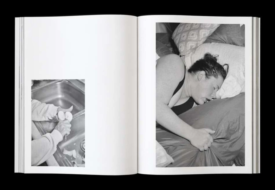Monochrome photo book spread featuring a person sleeping in bed and another peeling eggs in a sink, creating a juxtaposition of daily life.