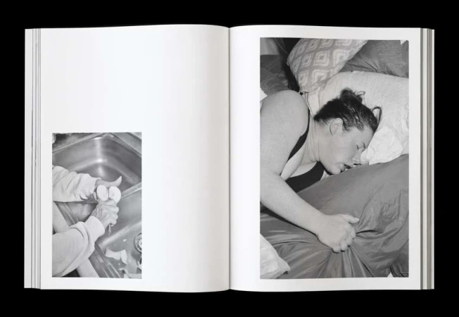 Monochrome photo book spread featuring a person sleeping in bed and another peeling eggs in a sink, creating a juxtaposition of daily life.