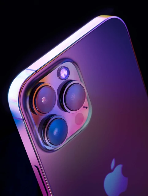 Close-up of the rear of a smartphone, showcasing the camera lenses, flash, and logo with a vibrant purple and pink color gradient.
