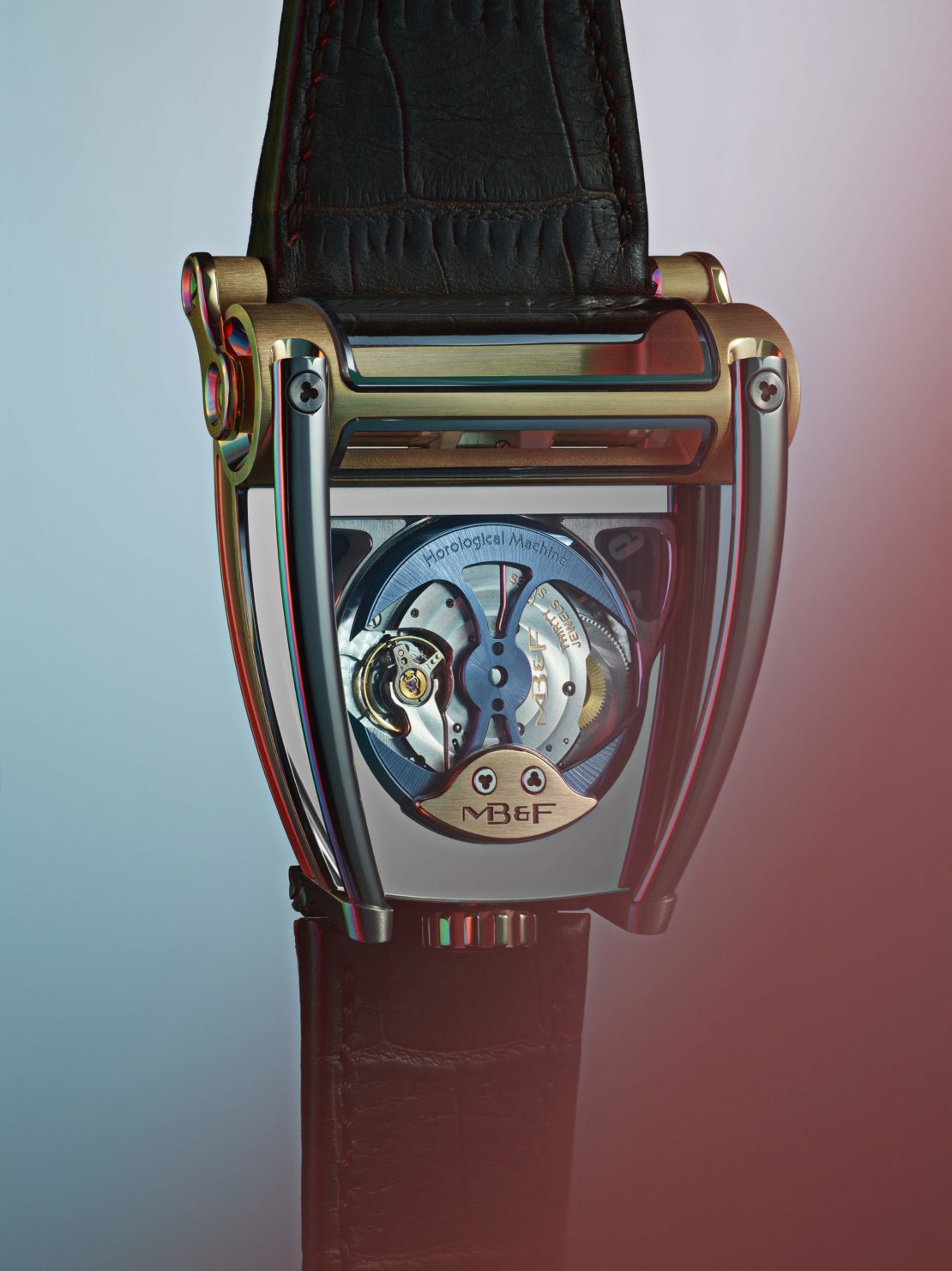 Close-up of a stylish MB&F Horological Machine No. 9 Flow watch with a black leather strap, showcasing its intricate mechanical details and design.