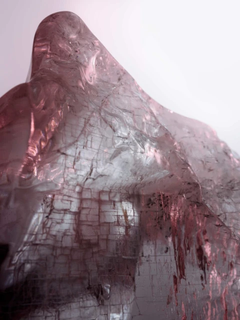 Abstract macro shot of textured rock formation. The geological stone appears to be illuminated with gradients of pink and white light.