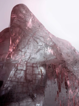 Abstract macro shot of textured rock formation. The geological stone appears to be illuminated with gradients of pink and white light.