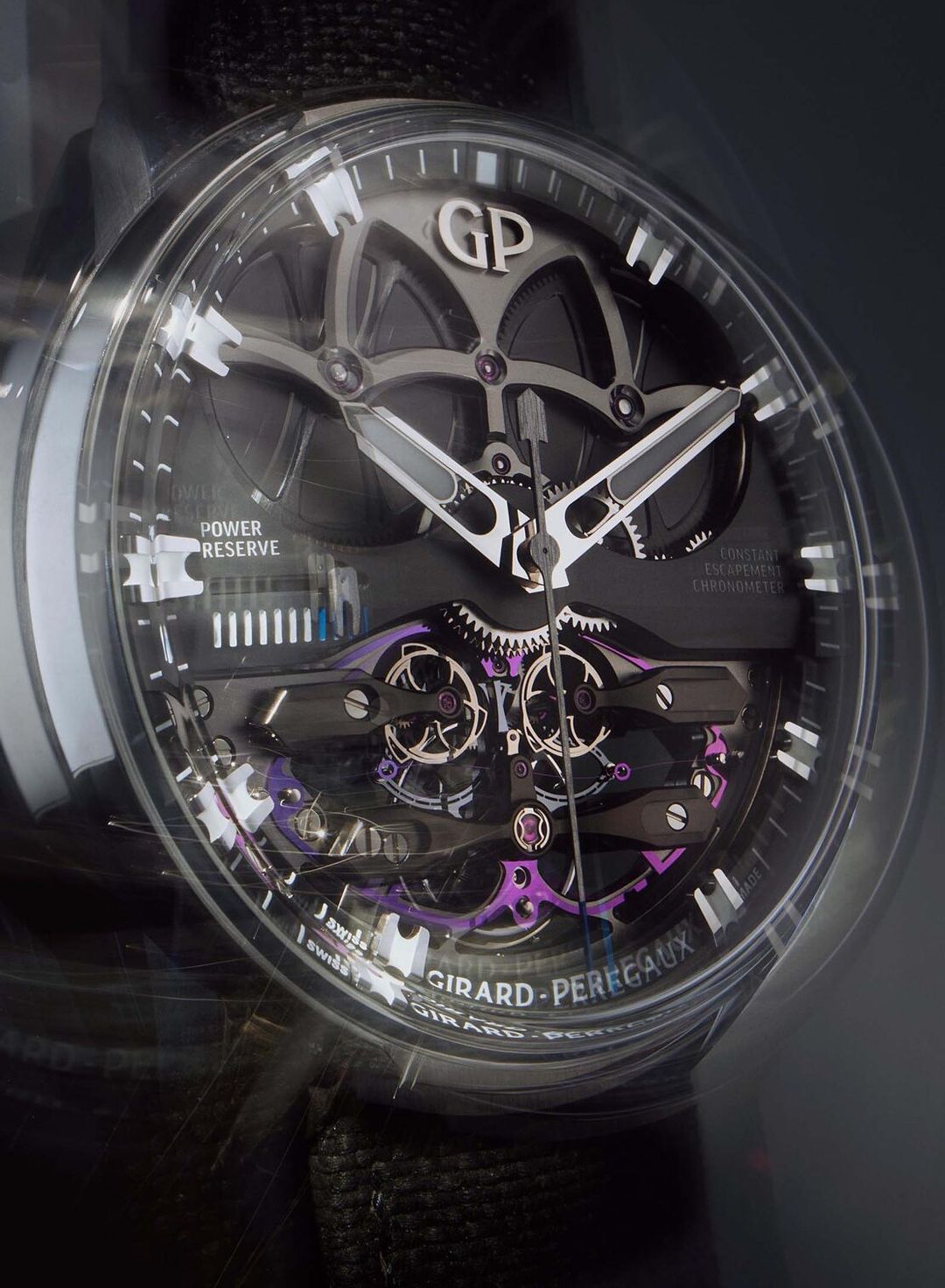 Close-up of a Girard-Perregaux wristwatch showcasing intricate internal mechanisms with purple and gray accents under studio lighting.