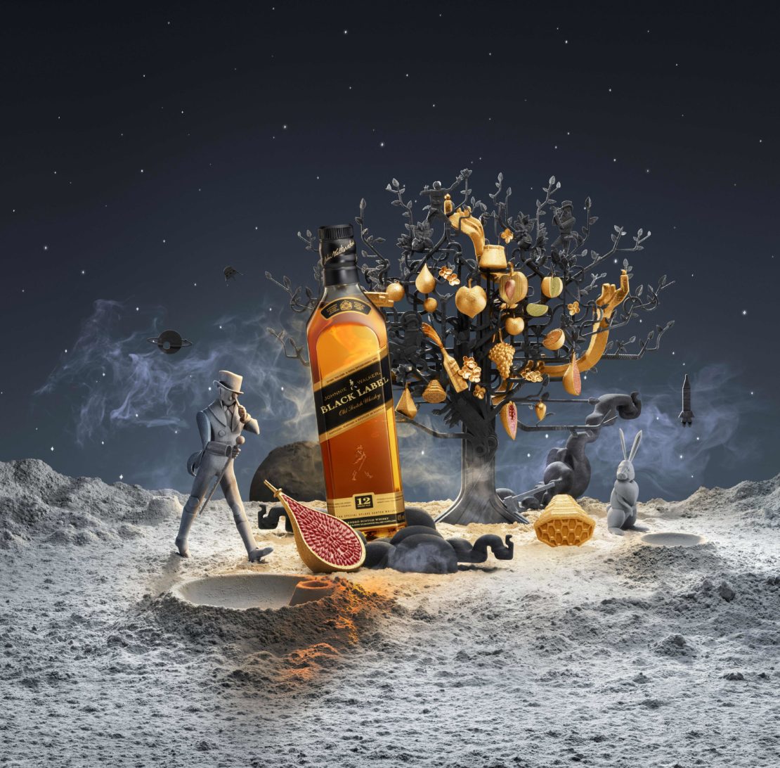 CGI still life of a bottle of Johnnie Walker Black Label whisky on a cratered moonscape surface with orbiting planets in the dark night sky.