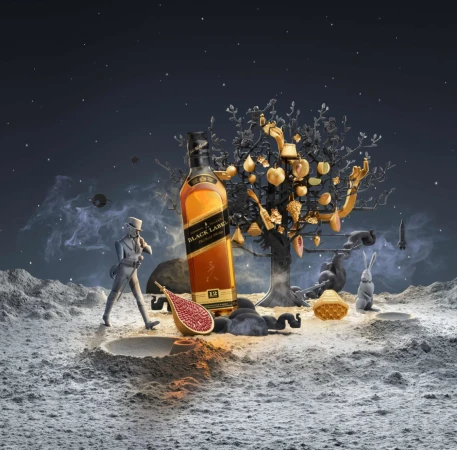 CGI still life of a bottle of Johnnie Walker Black Label whisky on a cratered moonscape surface with orbiting planets in the dark night sky.
