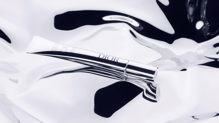 Dior skincare product tube on a reflective black and white surface, product shot for the beauty industry, luxury packaging.