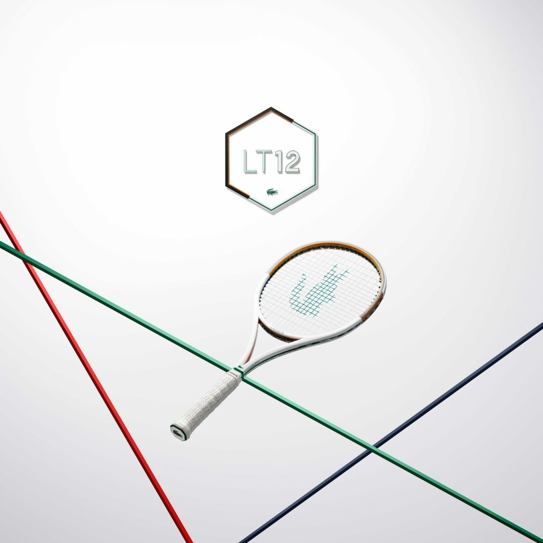 Tennis racket with red, green, and blue strings against a white background, featuring the Lacoste logo.