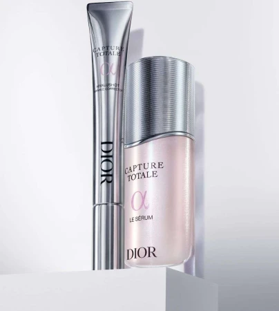 Close-up of Dior Capture Totale serum and wrinkle corrector, showcasing sleek, silver packaging on a clean white surface.