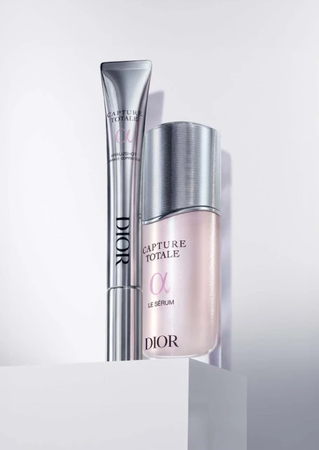 Dior Capture Totale skincare set featuring a serum bottle and eye serum tube in a studio setting with white background, close-up.