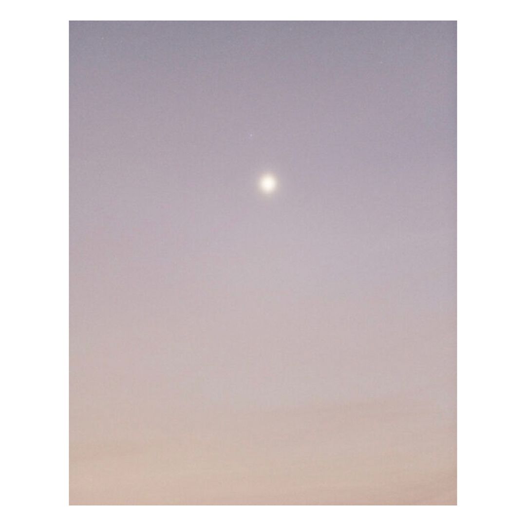 Sky at dusk with soft gradient of colors. Gradient from pale orange at the bottom to soft violet at the top with a bright celestial orb.