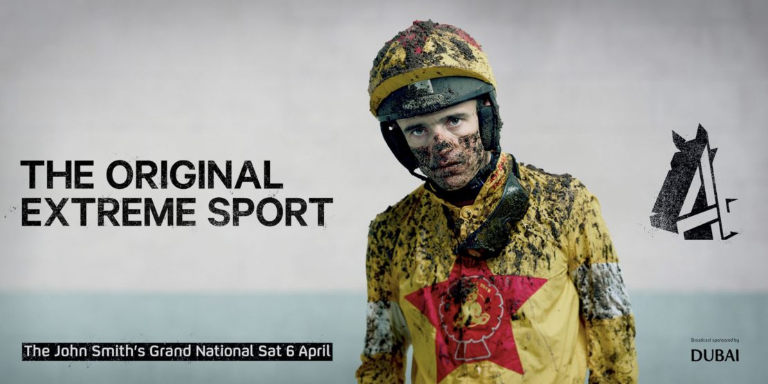 Horse racing promo image featuring a mud-covered jockey in yellow silks looking at the camera, with bold text promoting an upcoming event.