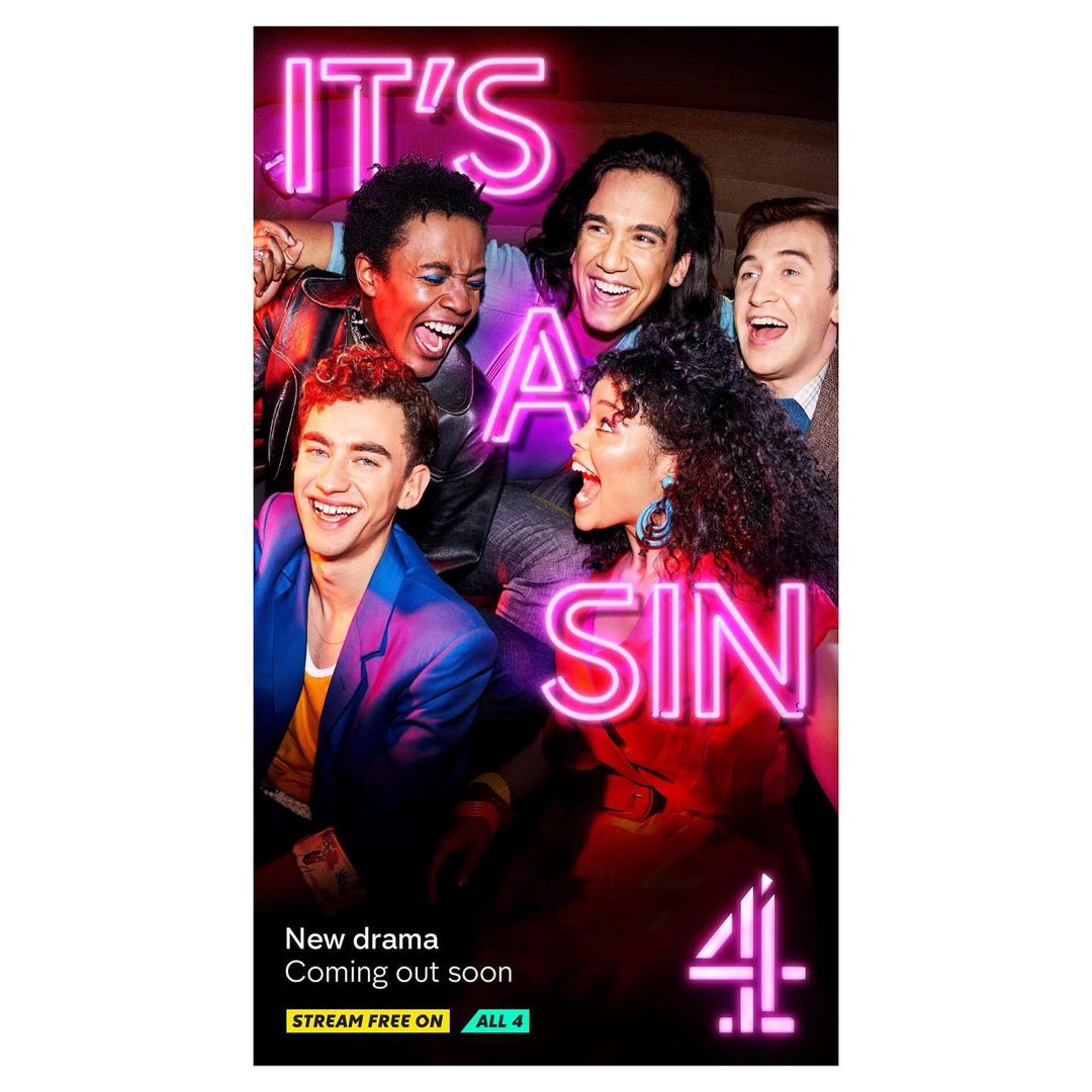A group of six diverse people smiling in a promotional image for a TV show called 'It's a Sin,' lit by a neon sign.