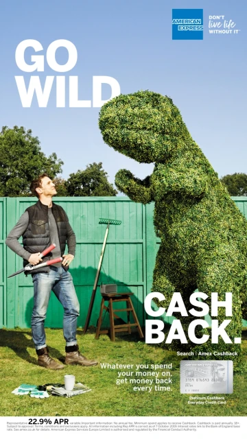 Commercial shot features an adult man standing in a yard next to a large dinosaur shaped hedge with text for American Express.