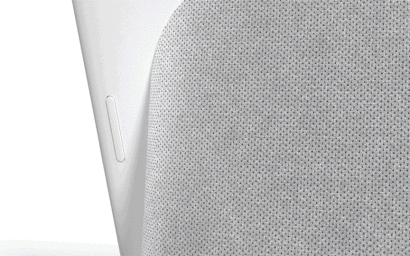 Close-up product shot of a light grey textured fabric surface with a smooth white plastic control button on the side.