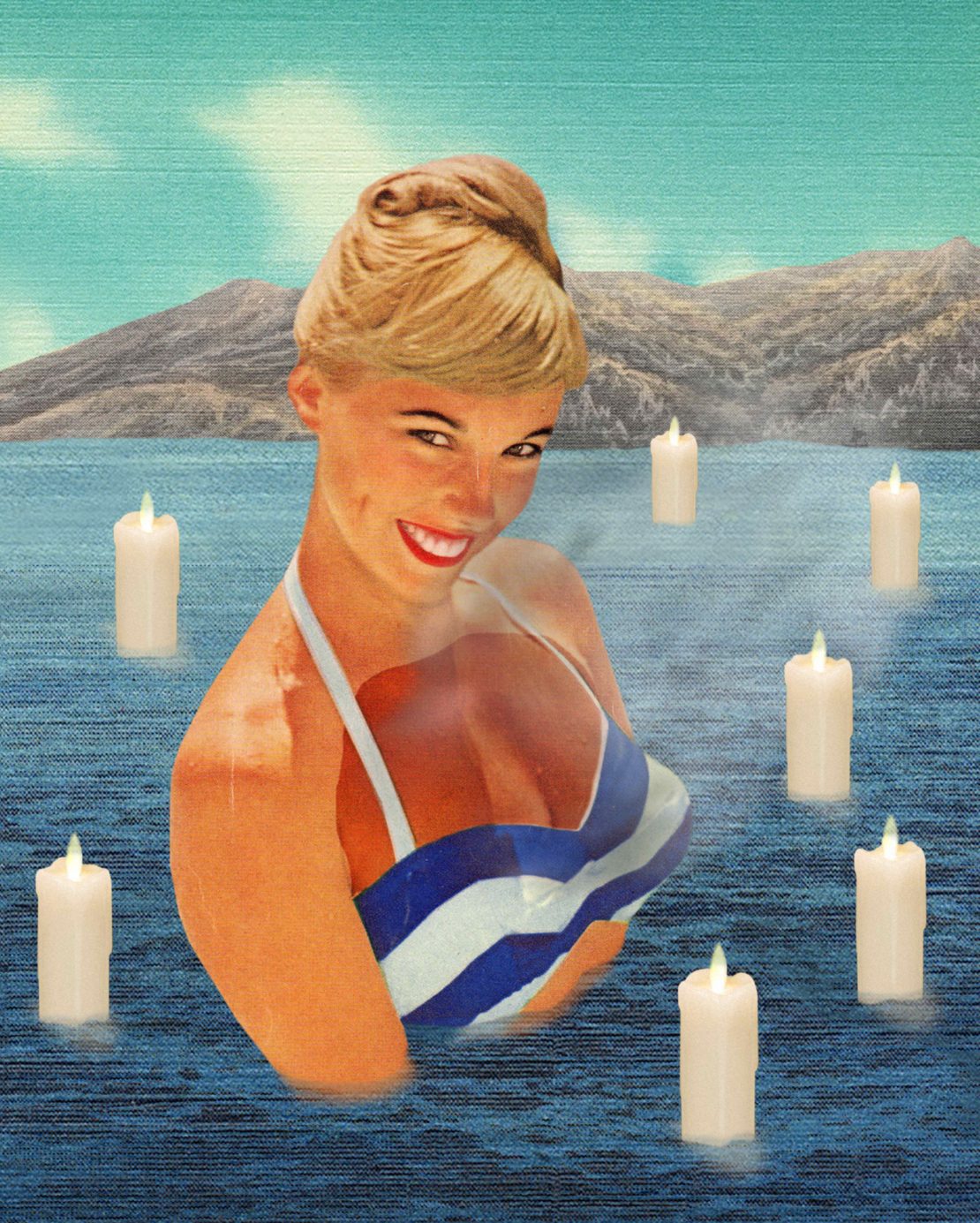 Blonde woman in a striped swimsuit surrounded by lit candles in a body of water, with a mountain and sky background.