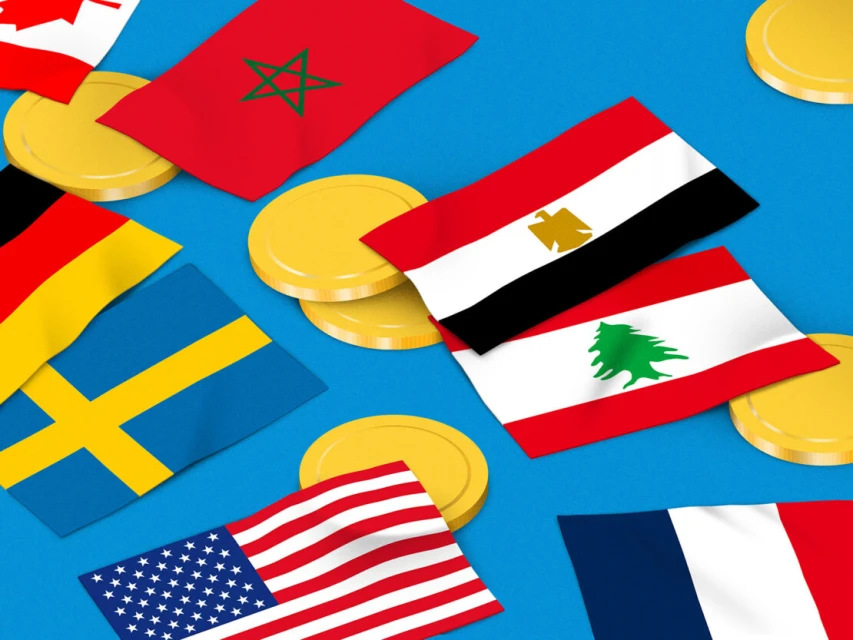 Overhead shot of national flags including the USA, France, Germany, Canada, Egypt, Sweden, Lebanon, and Morocco with gold coins scattered across light blue.