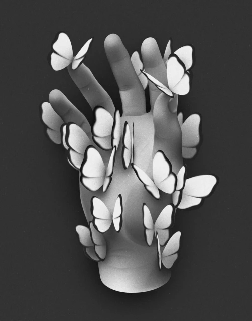 Monochromatic photo of a human hand adorned with numerous white paper butterflies against a dark backdrop, creating a surreal and artistic image.
