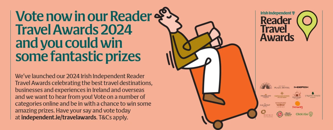 Cartoon illustration promoting Irish Independent Reader Travel Awards 2024, featuring a person riding an orange suitcase.